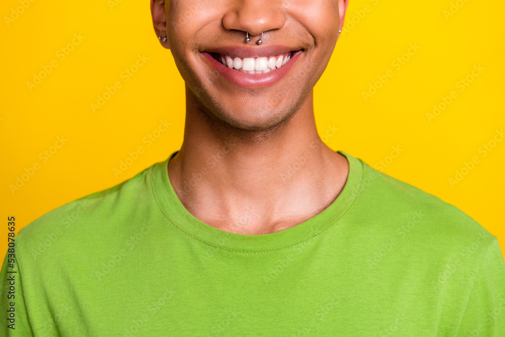 Close up photo of attractive young guy toothy smiling perfect healthy teeth dressed trendy green outfit isolated on yellow color background Close up photo of attractive young guy toothy smiling perfect healthy teeth dressed trendy green outfit isolated on yellow color background