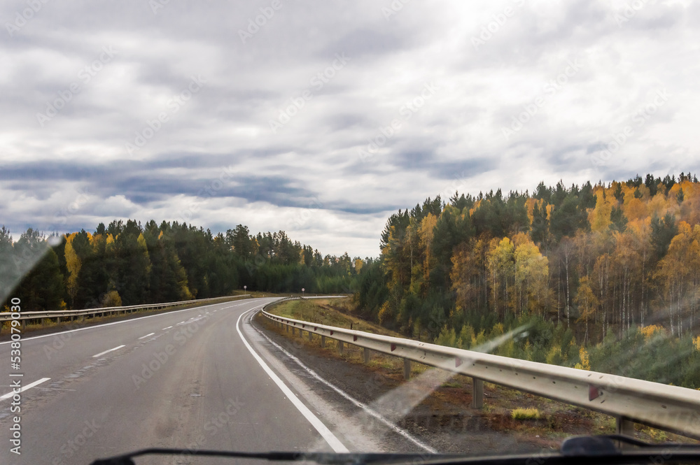 Fototapeta premium Autumn landscape. On the freeway. Travel by car.