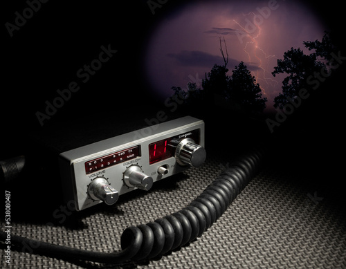 Storm building behind a survival radio on channel 11 photo