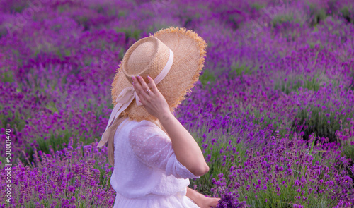 the girl is resting in the lavender field.