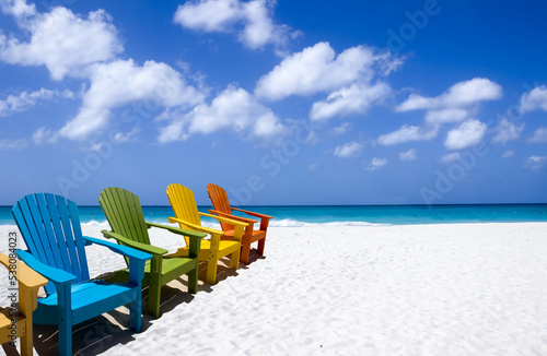 Colorful wooden chairs on white sand beach