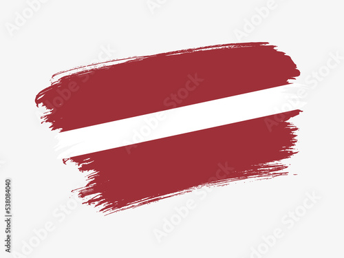 Latvia flag made in textured brush stroke. Patriotic country flag on white background