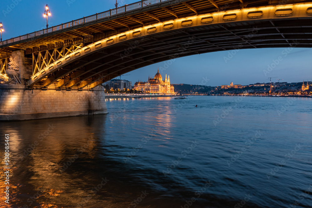 Danube river and Budapest Parliament under the bridge at night Danube river and Budapest Parliament under the bridge at night