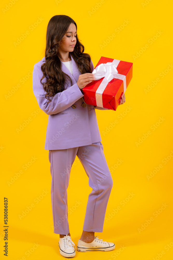 Teenager child with gift box, studio isolated background. Present for birthday, Valentines day, New Year or Christmas. Kid hold present box with gift ribbon bow. Teenager child with gift box, studio isolated background. Present for birthday, Valentines day, New Year or Christmas. Kid hold present box with gift ribbon bow.