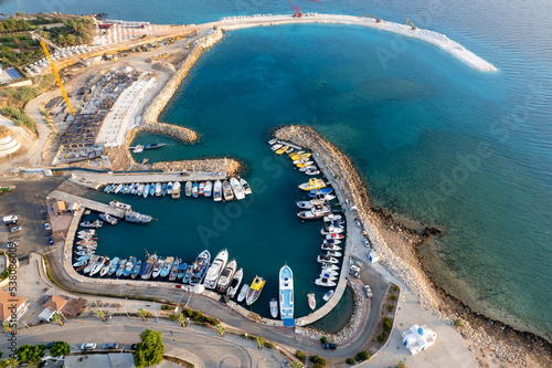 Drone aerial scenery fishing port at pernera Protaras Cyprus. Fishing boats moored in the harbour photo