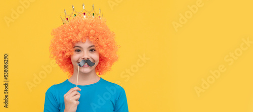 happy teen girl in fancy clown wig wear queen crown and funny party moustache, 1 april. Funny teenager child in wig, party poster. Banner header, copy space.