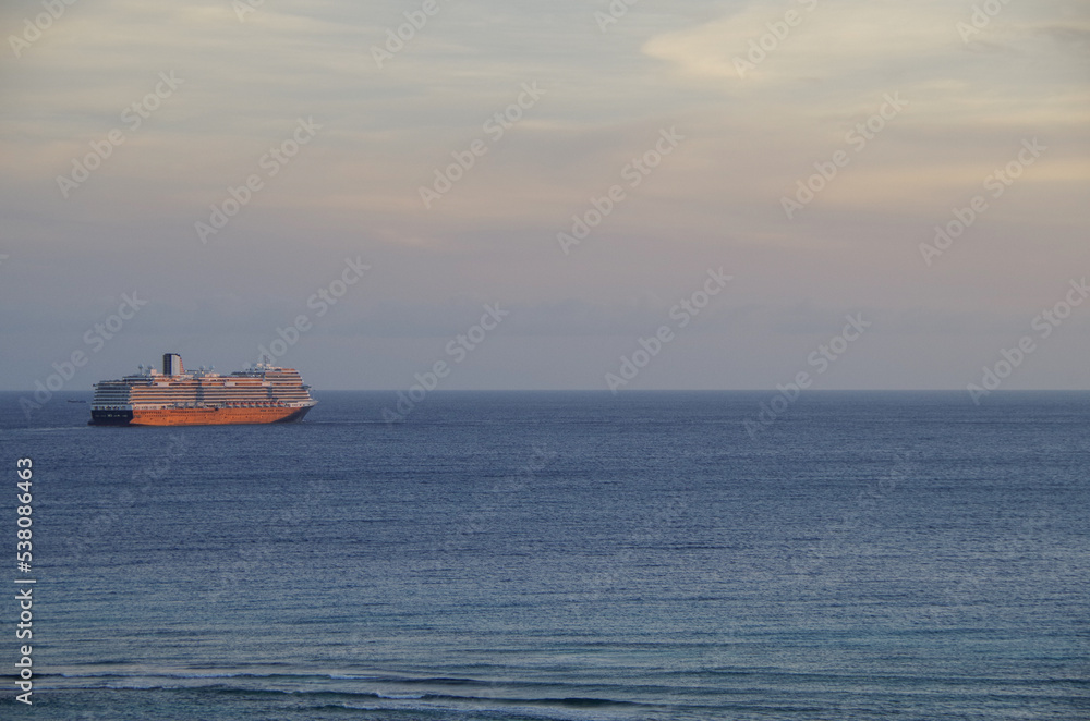 Modern HAL cruiseship or cruise ship liner Koningsdam sail away departure from port during Caribbean cruising dream vacation twilight blue hour sunset seascape landscape scenery Modern HAL cruiseship or cruise ship liner Koningsdam sail away departure from port during Caribbean cruising dream vacation twilight blue hour sunset seascape landscape scenery