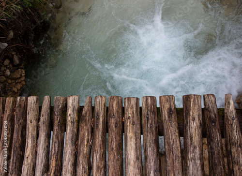 detail of wooden bridge with river