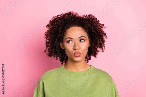 Photo of young pretty girl pouted lips look empty space dream romance isolated over pink color background
