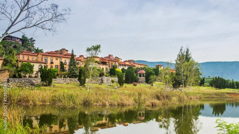 Time lapse of Italian-style building is on a mountain with a river beneath it like in a fairy tale. Time lapse of Italian-style building is on a mountain with a river beneath it like in a fairy tale.