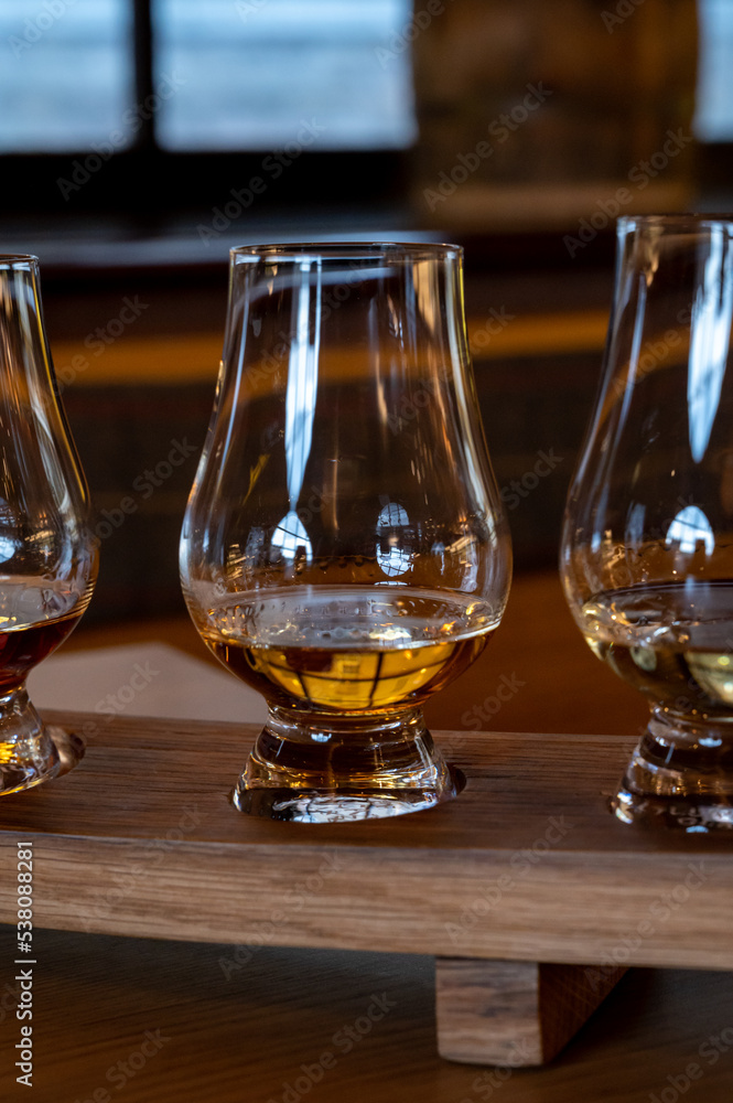 Flight of single malt scotch whisky in glasses served in whiskey bar in Edinburgh, UK Flight of single malt scotch whisky in glasses served in whiskey bar in Edinburgh, UK