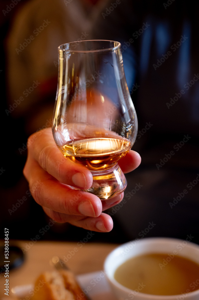 Tasting of single malt scotch whisky in whiskey bar in Edinburgh, UK Tasting of single malt scotch whisky in whiskey bar in Edinburgh, UK