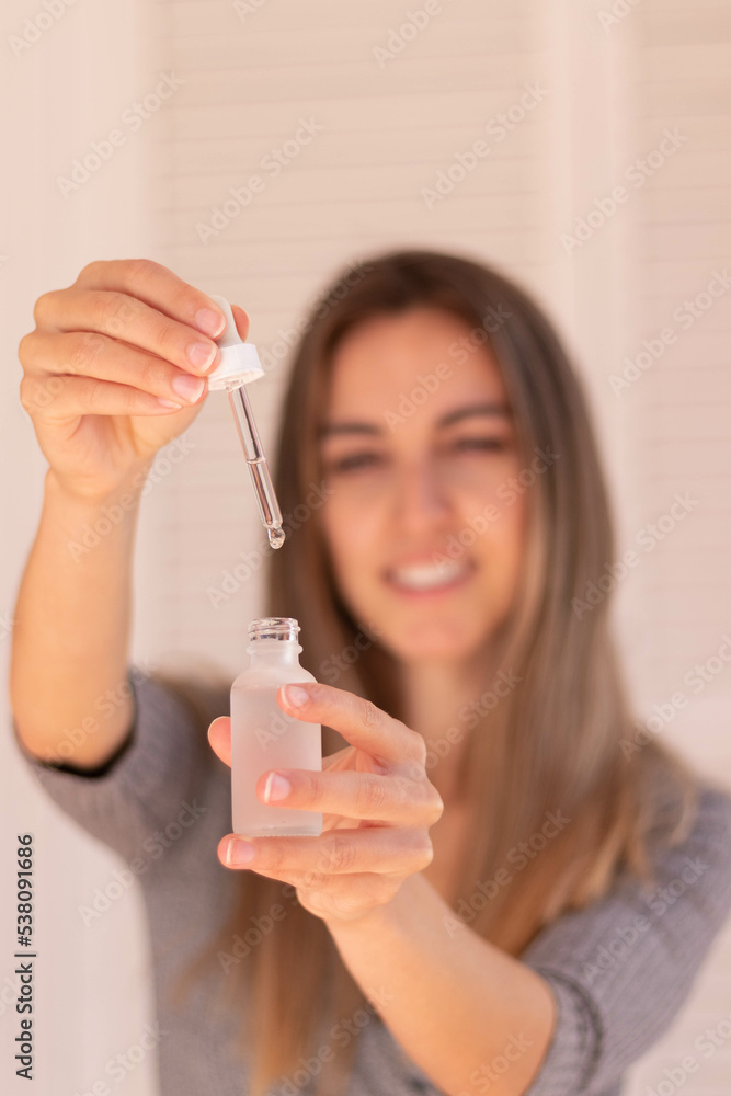 Vertical view of selective focus for pipette bottle for beauty and self care theraphy in white background Vertical view of selective focus for pipette bottle for beauty and self care theraphy in white background