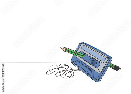 One single line drawing of tangled analog cassette tape ribbon rotate by wooden pencil. Vintage musical item concept continuous line draw design vector illustration graphic