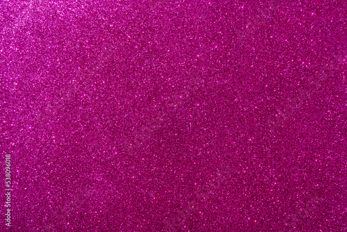 Background with sparkles. Backdrop with glitter. Shiny textured surface. Dark pink
