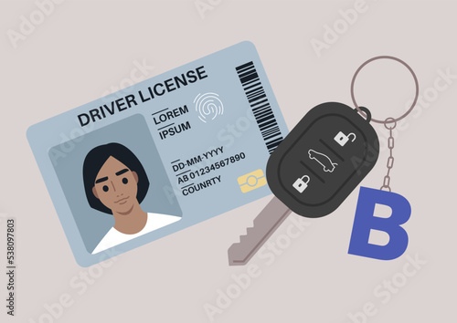 A driver license plastic card with a photo, a car starter key with a keychain