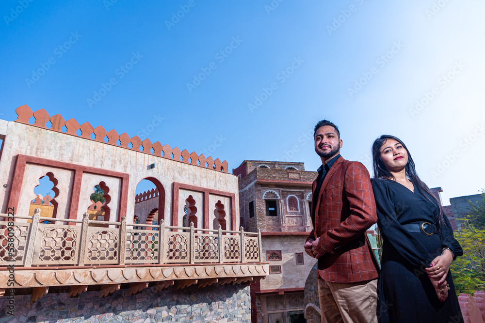 A young Indian couple shooting their pre wedding at a heritage fort in Delhi India. Romantic couple having shoot Delhi. Best young couple India. Pre wedding Indian couple.