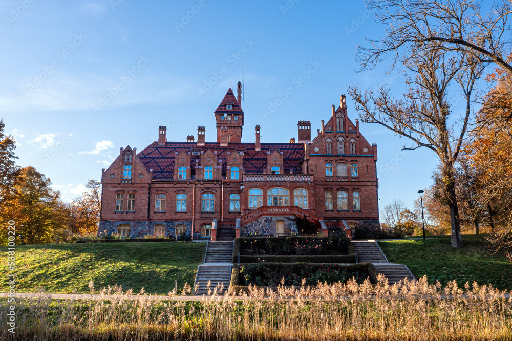 Obraz premium Jaunmoku Brick Medieval Castle Near Tukums, Latvia on a clear sunny autumn day, drone view