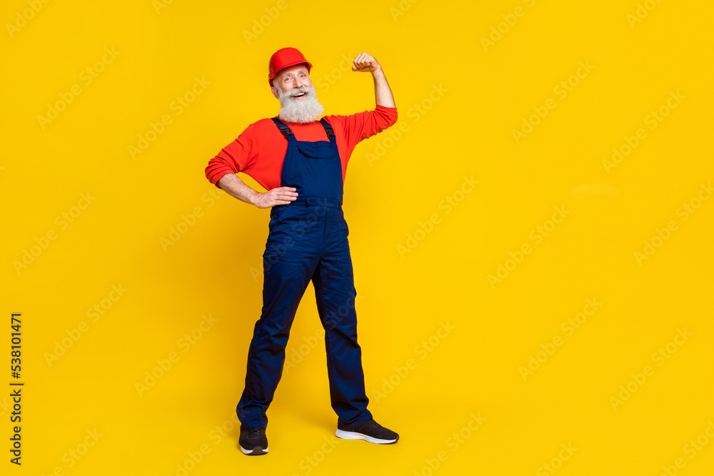 Full size photo of workman grandfather feel confident repair buildings show biceps isolated bright color background Full size photo of workman grandfather feel confident repair buildings show biceps isolated bright color background