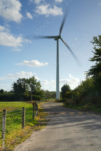 Image depicting motion of a horizontal axis wind turbine with slightly blurred blades in South Staffordshire in the UK photo
