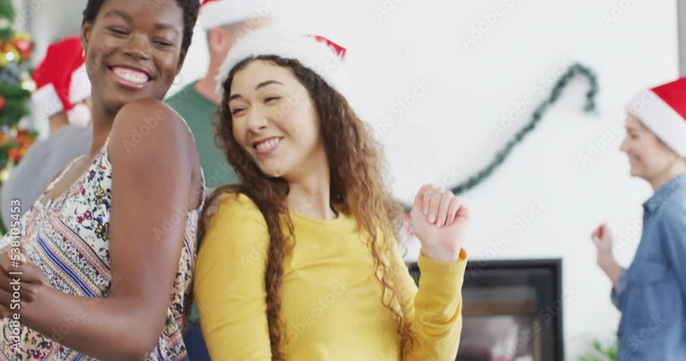Happy group of diverse friends dencing at christmas party Happy group of diverse friends dencing at christmas party