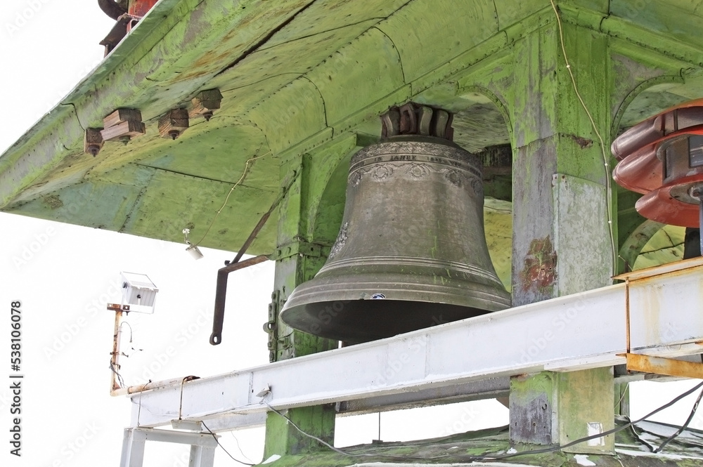 A bell mounted on a high tower in the city of Lviv, Ukraine.