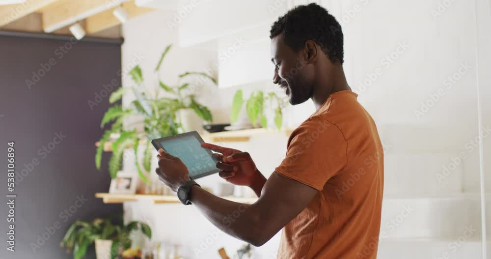 Happy african american man using tablet with weather forecast Happy african american man using tablet with weather forecast