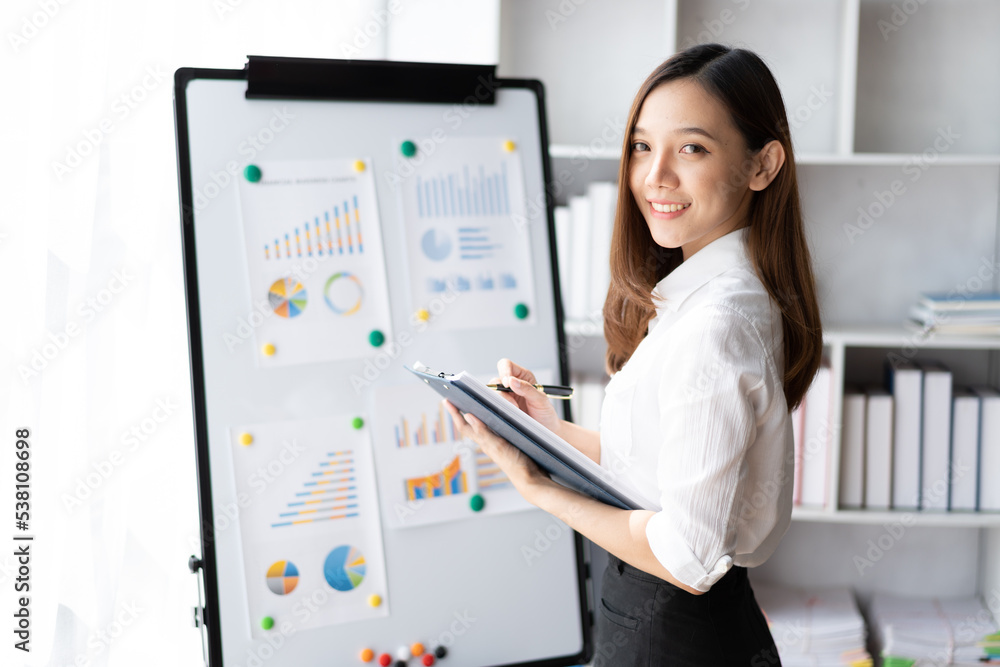 Beautiful Asian business woman working at the office With financial report. Beautiful Asian business woman working at the office With financial report.