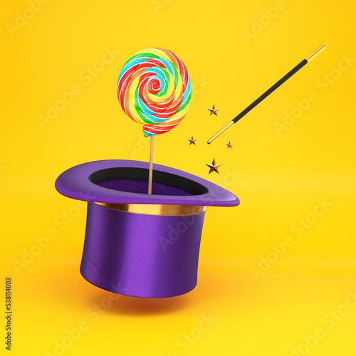 Fotografie A magic hat with a wand and a lollipop on a stick floating on a yellow backgroun