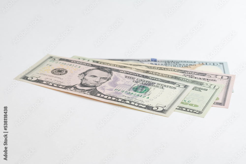 5, 20, 50, 100 dollars banknotes at different angles. Close up of dollars on white background. 5, 20, 50, 100 dollars banknotes at different angles. Close up of dollars on white background.