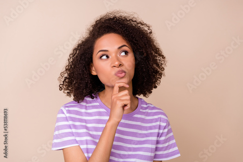 Photo of cute dreamy lady wear violet t-shirt arm chin looking empty space isolated beige color background