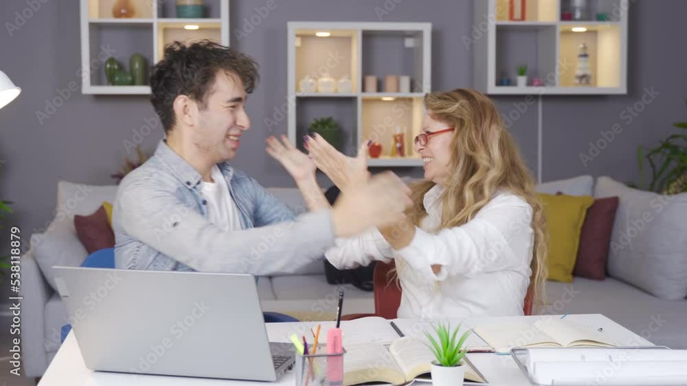 The mother rejoices with her successful son who is the winner.
Young man looking at laptop wins and happily hugs his mother.
The mother rejoices with her successful son who is the winner.
Young man looking at laptop wins and happily hugs his mother.