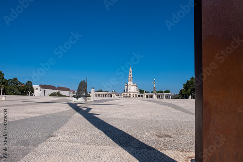 The Sanctuary of Fatima, Portugal. view to the back of the Statue of Saint Pope John Paul II and the Basilica of Our Lady of the Rosary in background.  photo
