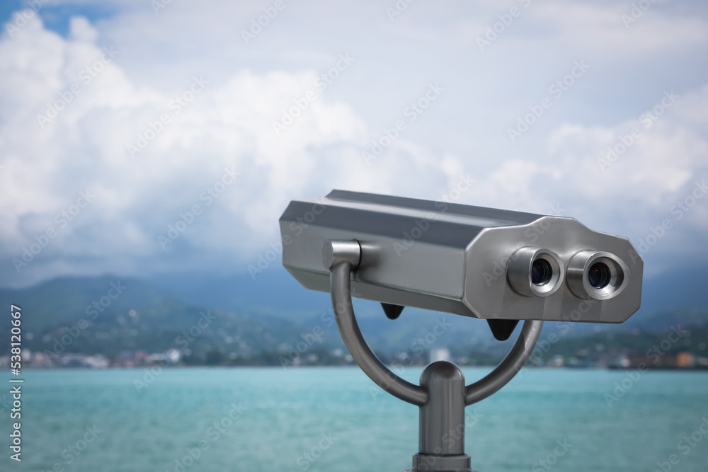 Metal tower viewer installed near sea, space for text. Mounted binoculars Metal tower viewer installed near sea, space for text. Mounted binoculars