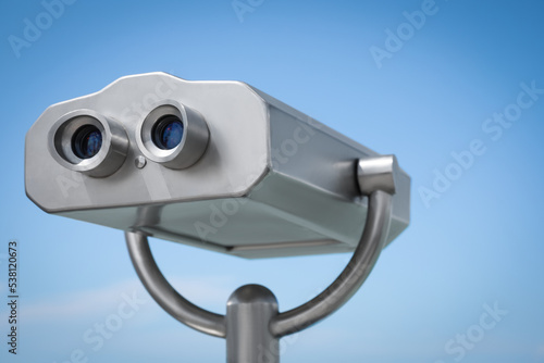 Metal tower viewer against blue sky, closeup. Mounted binoculars