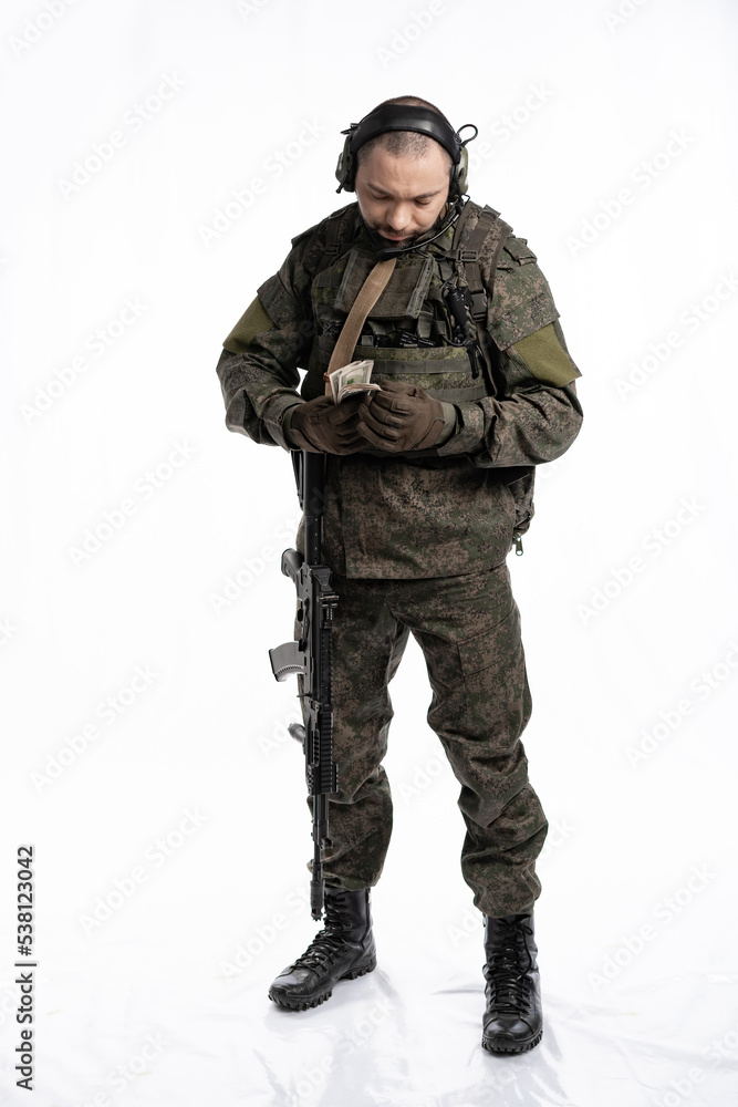 soldier in the studio on a white background. a man in military uniform with a rifle or machine gun. military or airball player soldier in the studio on a white background. a man in military uniform with a rifle or machine gun. military or airball player