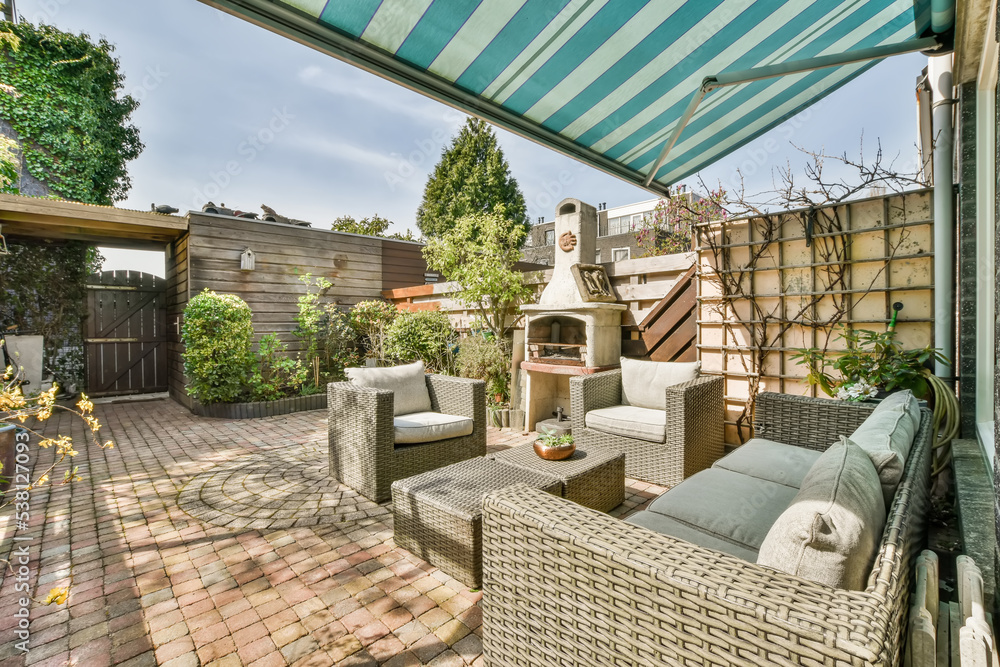 Backyard of a house with table and sofa Stock Photo | Adobe Stock