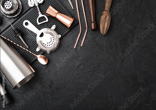 Schilderij op canvas Copper bar spoon with straw and jigger on rubber bar tray with stainles steel shaker and strainer