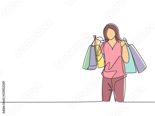One single line drawing young happy beauty woman holding paper bags after buying dress, fashion, make up, cosmetic at mall. Commercial retail shopping concept. Continuous line draw design illustration