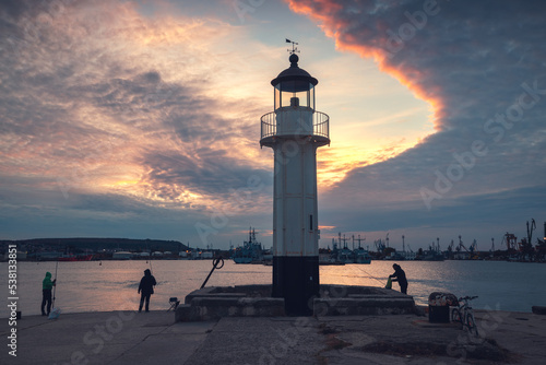 Coastal lighthouse scenic sunset with dramatic clouds in the harbour. Beacon near the beach in Varna, Bulgaria