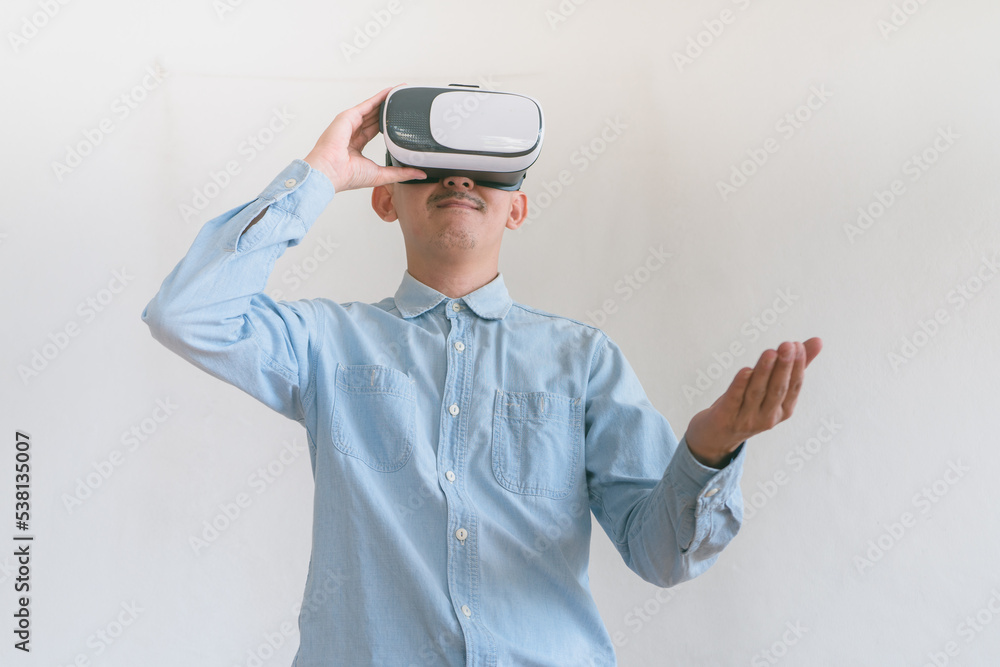 business man using virtual reality headset. Isolated on gray background studio portrait. VR, future, technology, education online, studying . Studio shot on gray business man using virtual reality headset. Isolated on gray background studio portrait. VR, future, technology, education online, studying . Studio shot on gray
