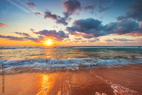 Fototapeta Naklejka Na Ścianę i Meble -  Beautiful sunrise over the sea waves and beach on tropical island beach