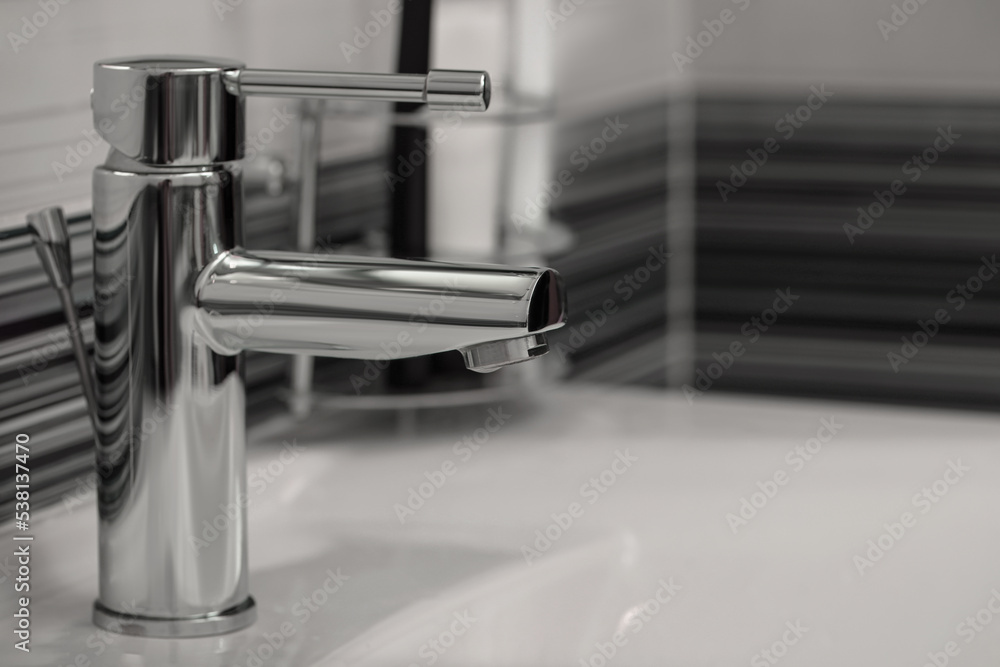 Clean white sink with shiny water tap in bathroom Clean white sink with shiny water tap in bathroom