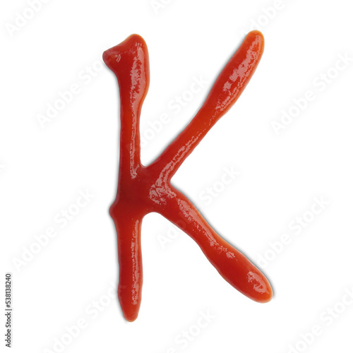 Letter K written with ketchup on white background
