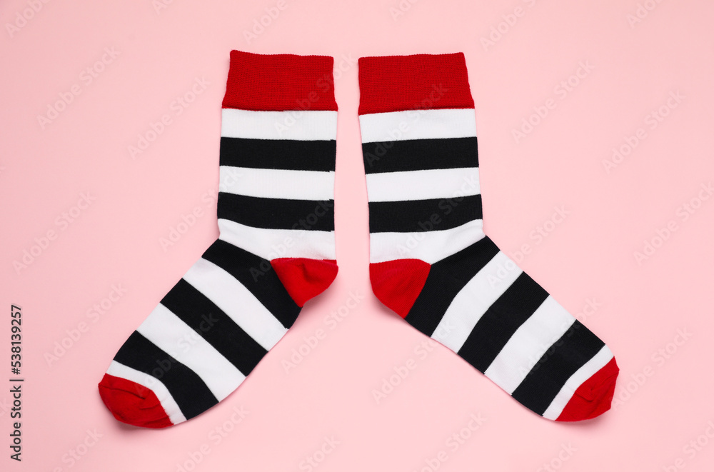 Striped socks on pink background, flat lay Striped socks on pink background, flat lay