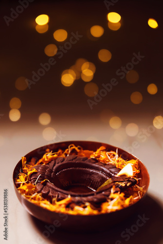 Diwali is the festival of lights. Lit Burning decorative Diya with bokeh isolated in black background with copy space.
