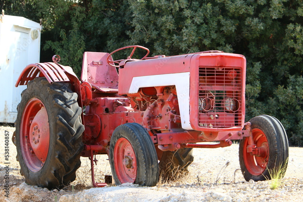 Old agricultural machinery stands on the street in Israel and rusts Old agricultural machinery stands on the street in Israel and rusts