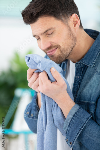 houseman is smelling clean laundry photo