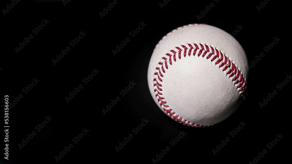 White leather baseball poses on black background. White leather baseball poses on black background.