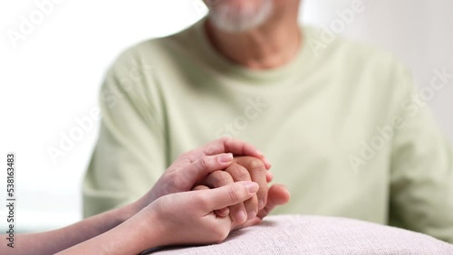 Asian caregiver holding hands senior elderly old male take care mental health care at nursing home. 